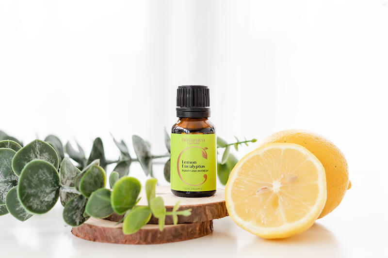 Lemon Eucalyptus Oil with plant and lemon slice